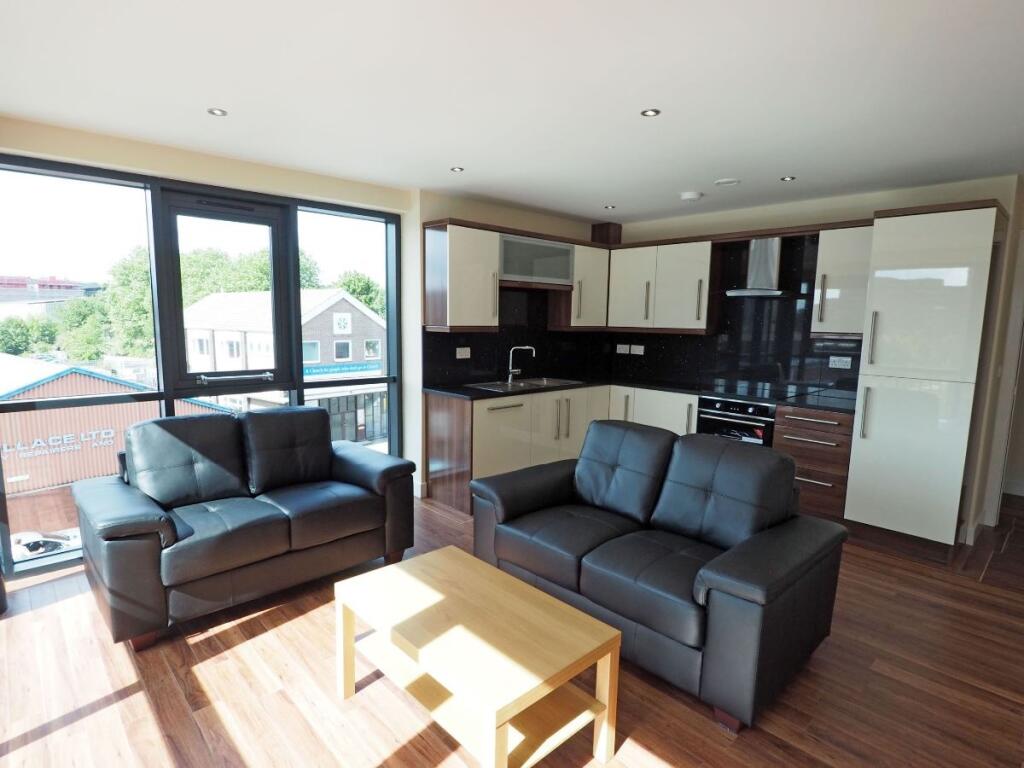 Bright and modern living room featuring large w...
