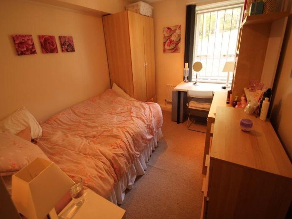 Cozy furnished bedroom with a single bed, wardr...