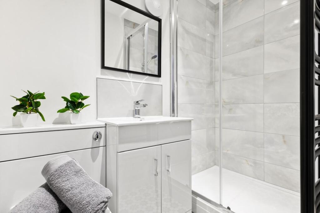 A modern and stylish bathroom featuring a sleek...