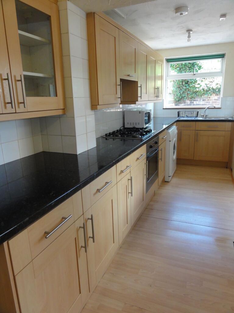 Bright and well-maintained kitchen featuring na...