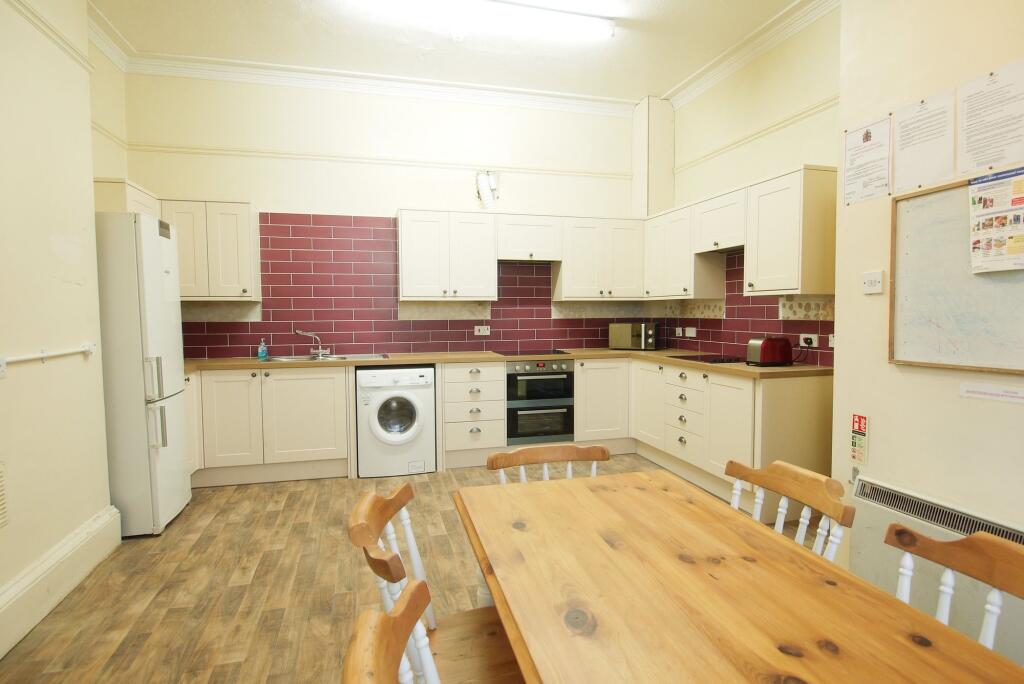 Bright and spacious kitchen featuring ample cab...