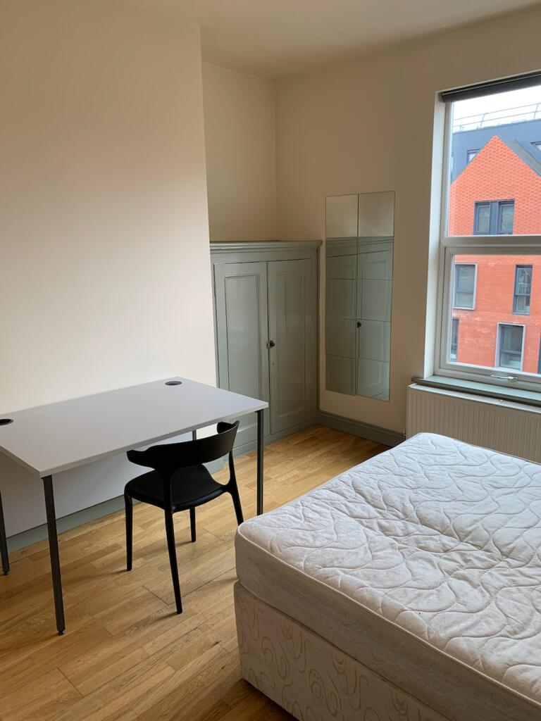 A bright and spacious double bedroom featuring ...