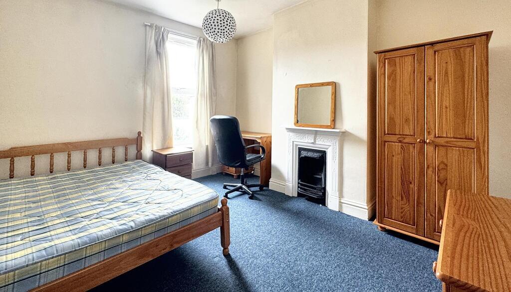 A well-maintained double bedroom featuring a wo...