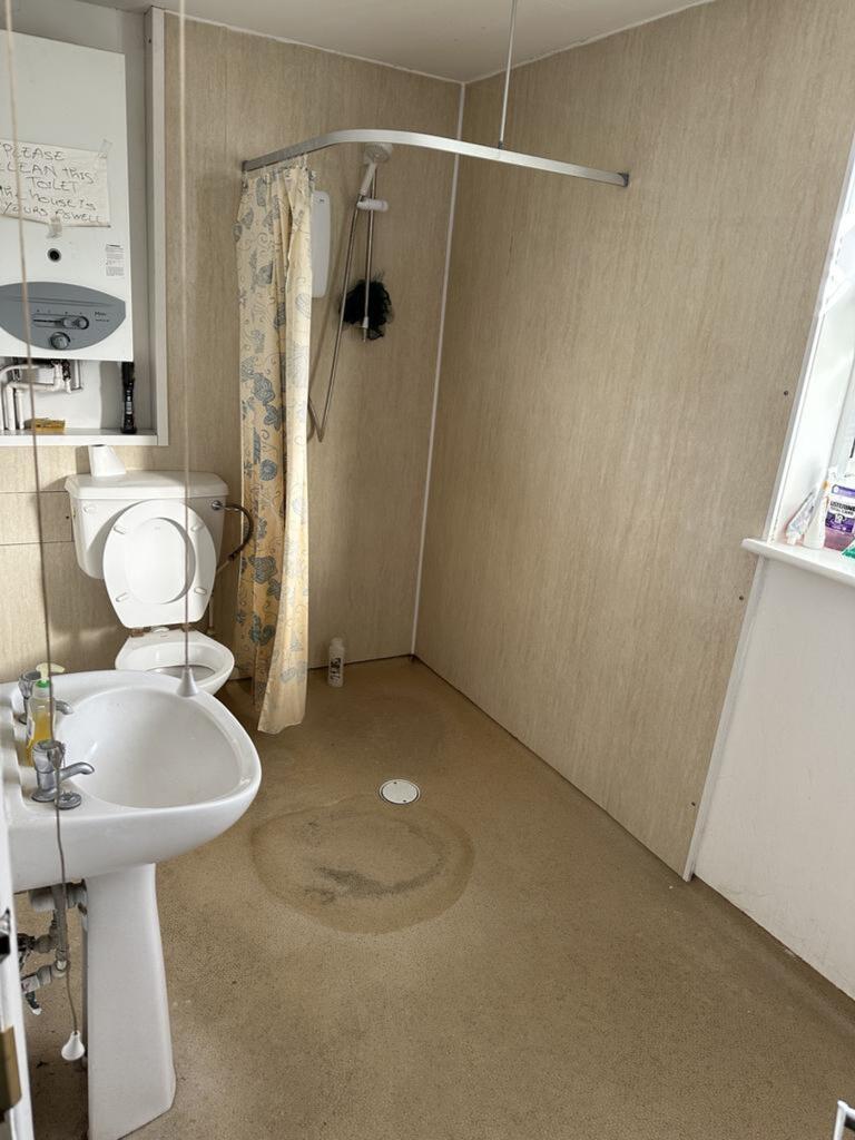 A functional bathroom with a shower, offering e...