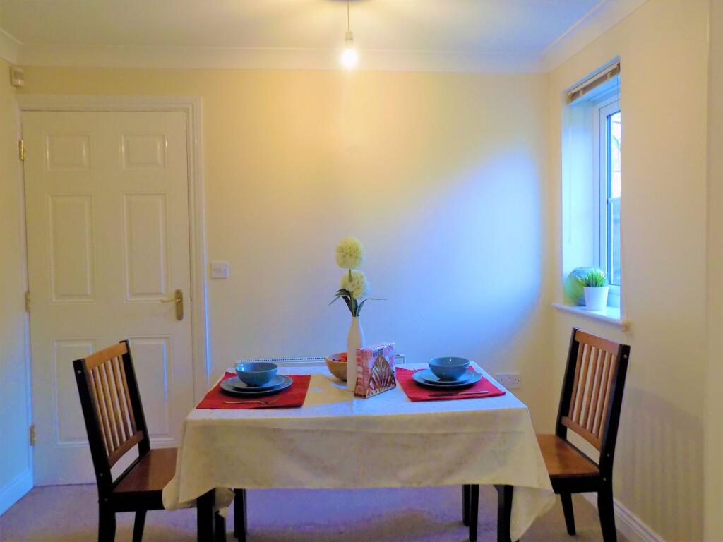 A cozy dining area featuring a neatly set table...
