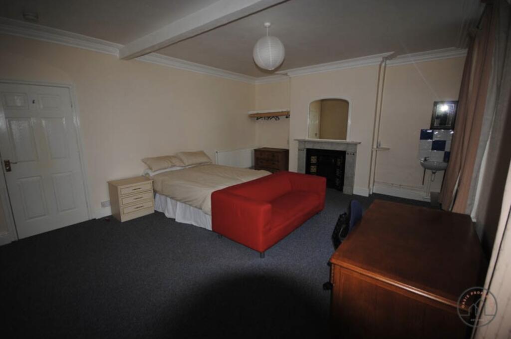 Spacious master bedroom with ample space for a ...