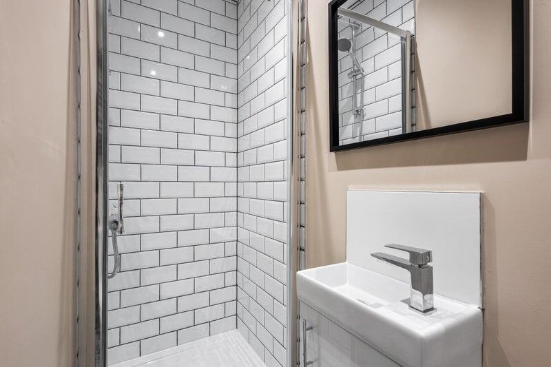 A modern bathroom featuring a stylish walk-in s...