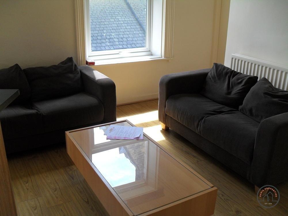 A bright, well-maintained living room featuring...