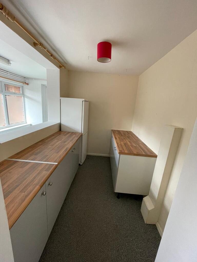 A neat and functional kitchen space with wooden...