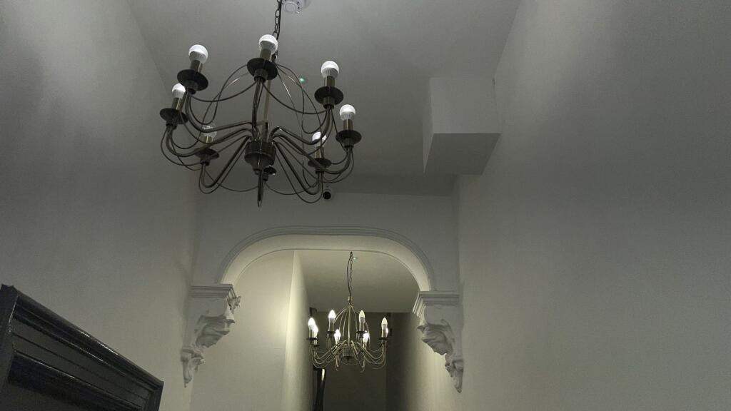 A tastefully designed hallway featuring elegant...