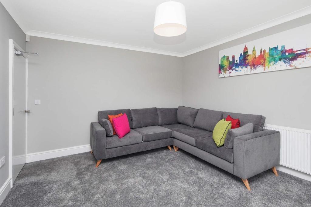 This inviting living room features a comfortabl...