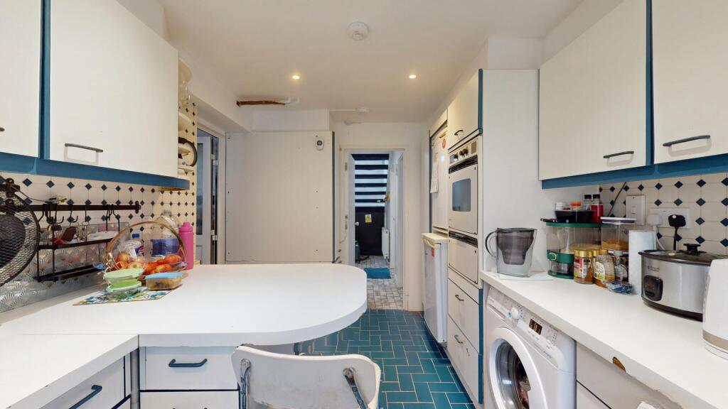 Bright and modern kitchen with ample workspace,...