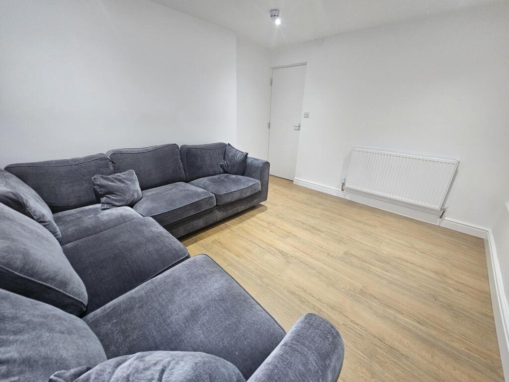 Spacious and well-maintained living room featur...