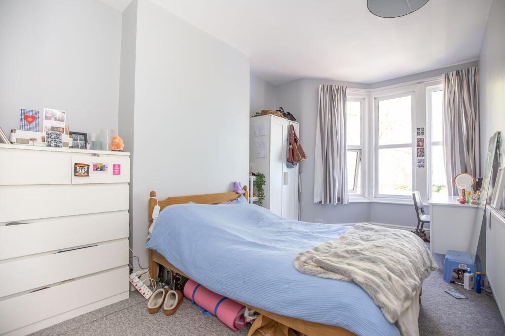 Bright and cozy double bedroom featuring a larg...
