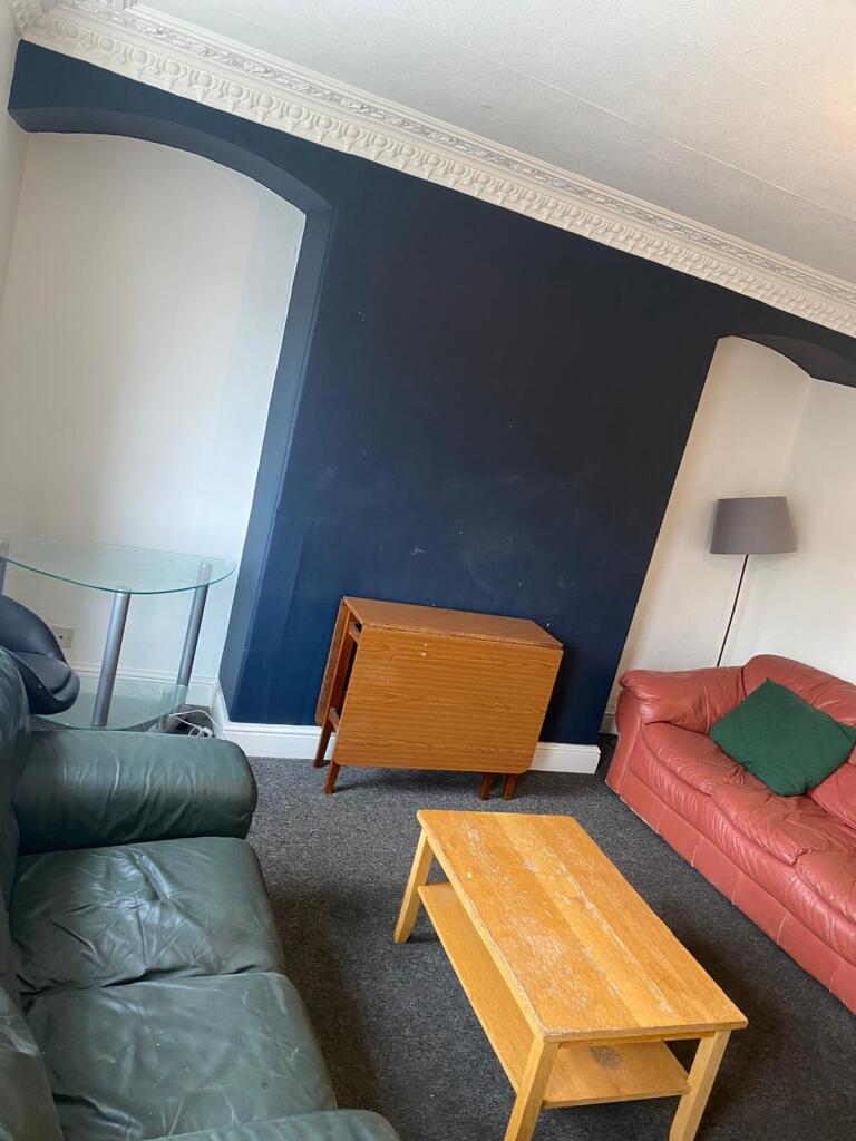 A cozy living room featuring a mix of leather s...