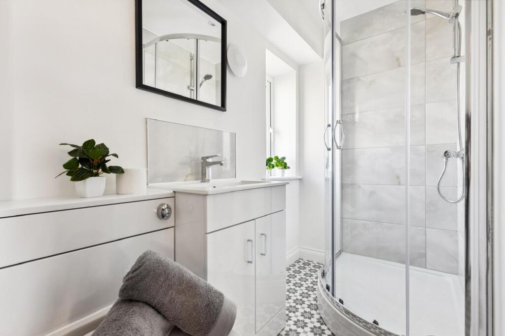 A bright and modern bathroom featuring a sleek ...