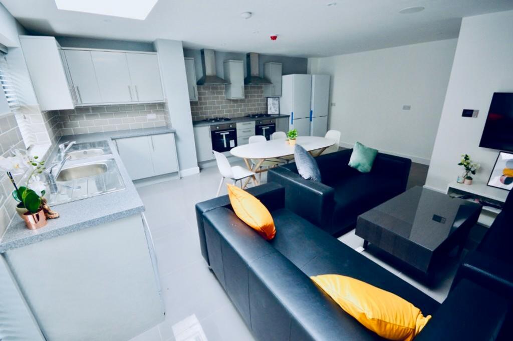 A spacious and stylish living room featuring mo...