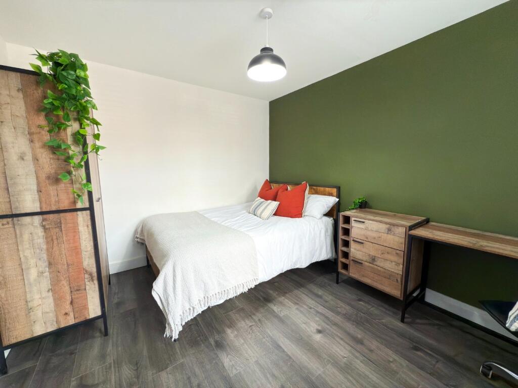 A bright and tidy single bedroom featuring a co...