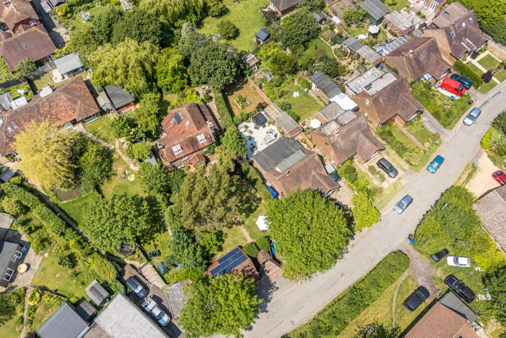 Aerial view of house, plot and detached double garage at the front