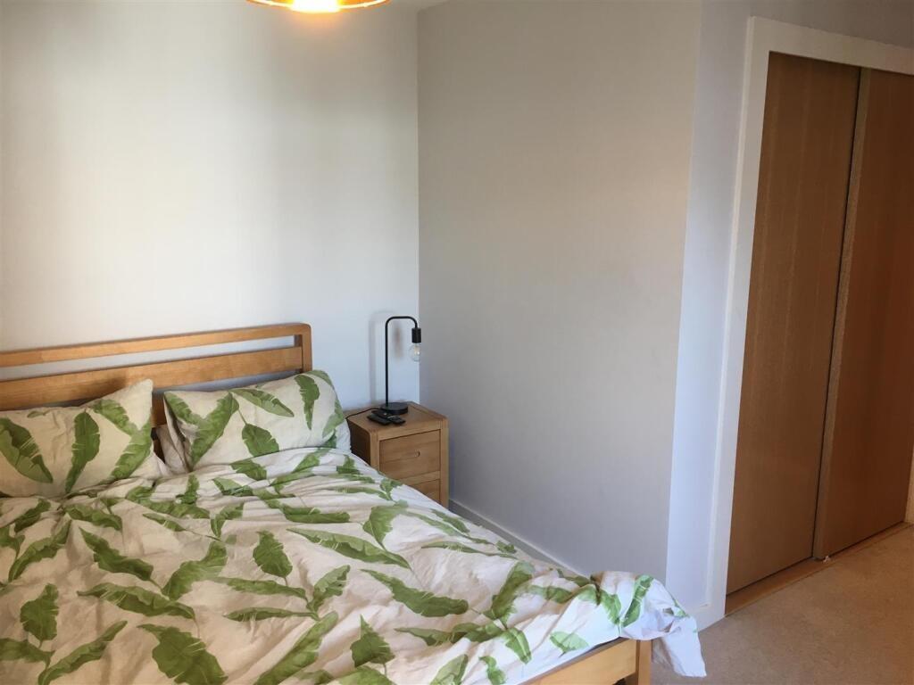 A cozy double bedroom featuring a comfortable d...