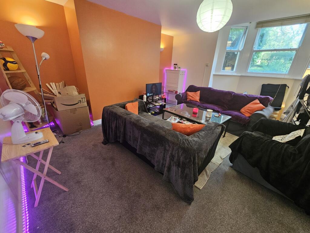 A cozy living room featuring a large sofa, a co...