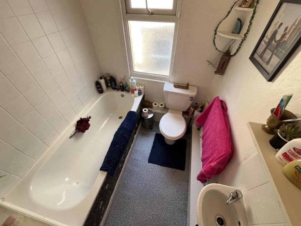 A tidy bathroom featuring a bath and modern fix...