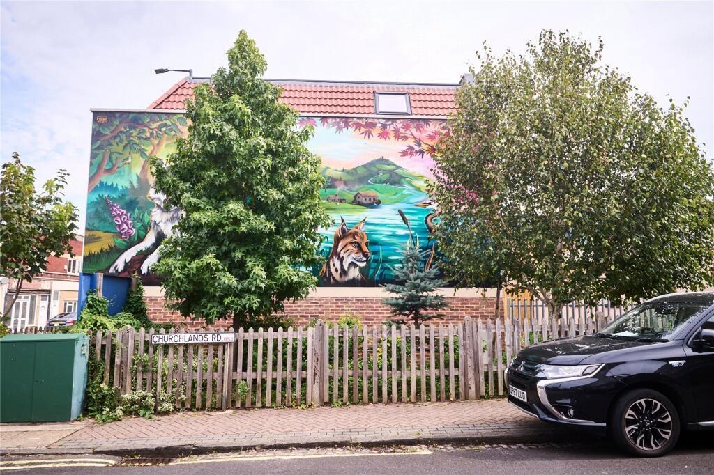 Charming terraced house with a vibrant mural on...