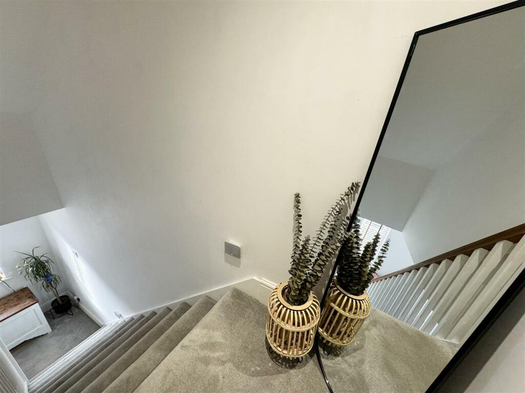 STAIRS LEADING TO THE SECOND FLOOR