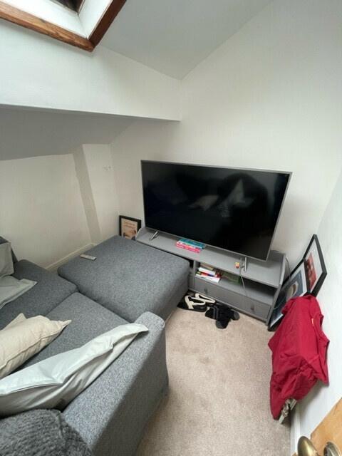 A cozy living room featuring a large flat-scree...
