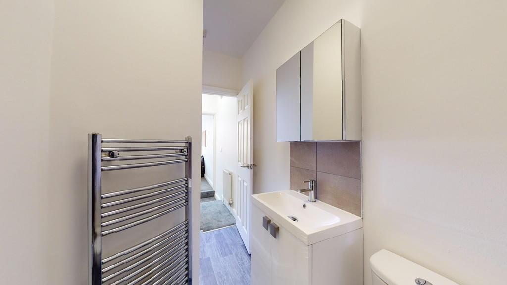 Bright and modern bathroom featuring a sleek va...