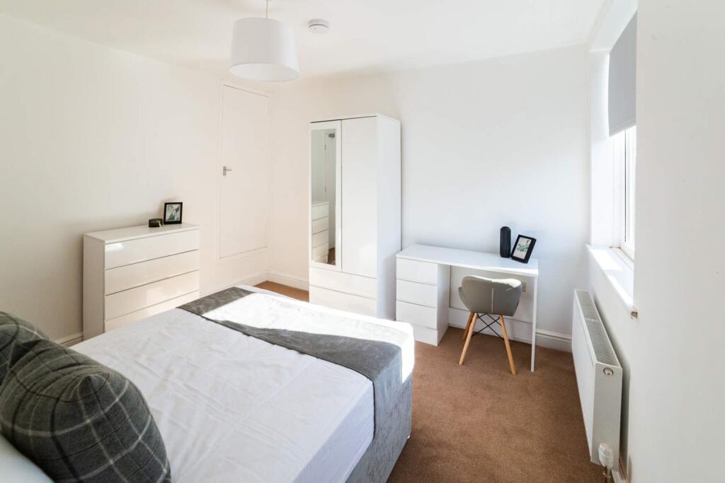 Spacious double bedroom featuring a cozy atmosp...