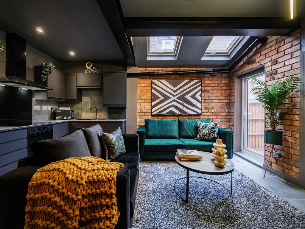 Contemporary living room with stylish exposed b...