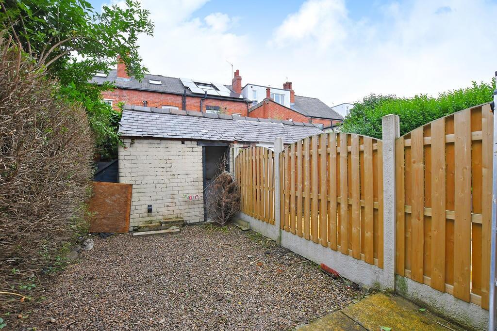 A neat and private garden space featuring a woo...