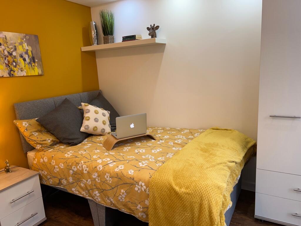 A vibrant and cozy double bedroom featuring war...