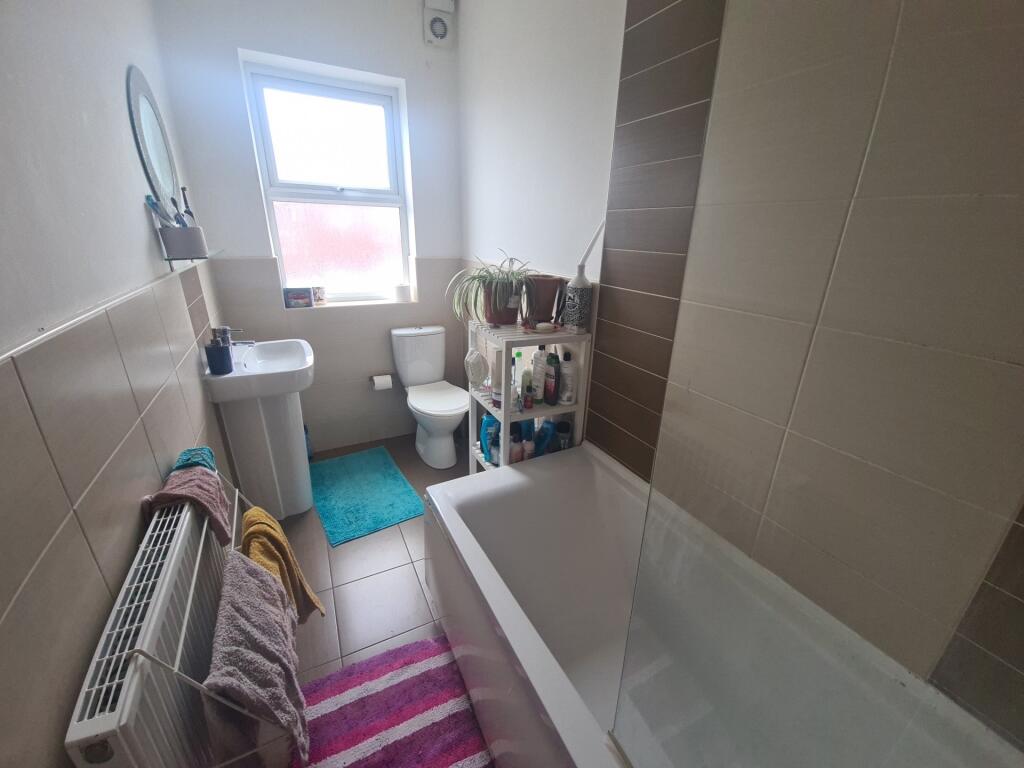 A well-maintained bathroom featuring a large ba...