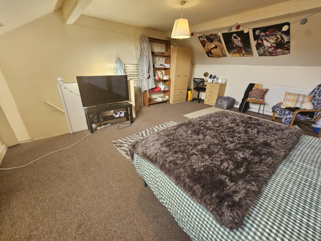 Spacious and cozy master bedroom featuring a la...