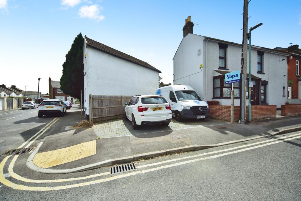 Outside View Of The Property With Driveway Parking