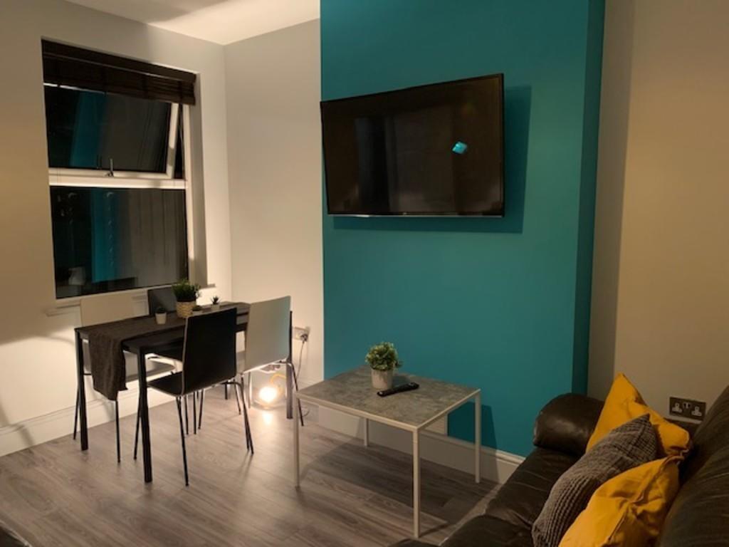 Contemporary living room with a sleek TV mounte...