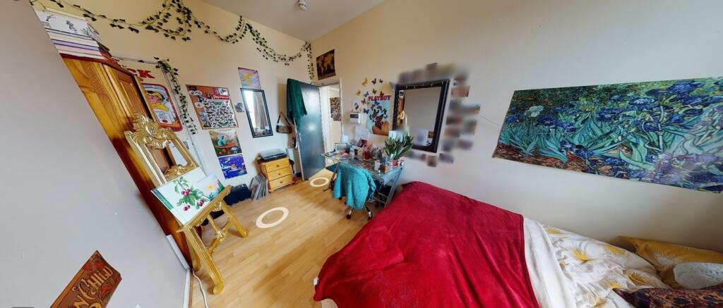 A vibrant double bedroom filled with character,...