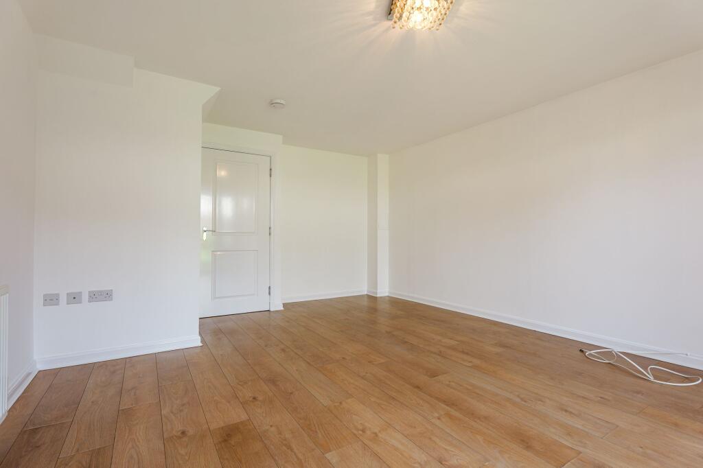 Lounge with Beautiful Flooring. Door Separating View Towards Entry Hall.
