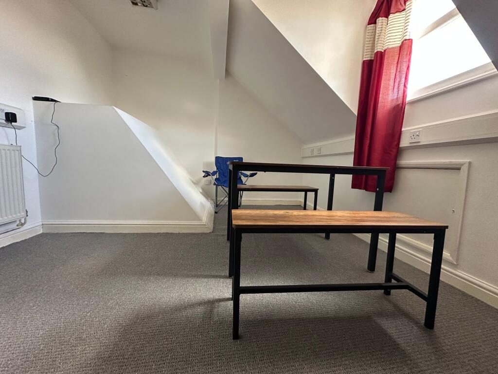 Bright communal workspace featuring a modern ta...