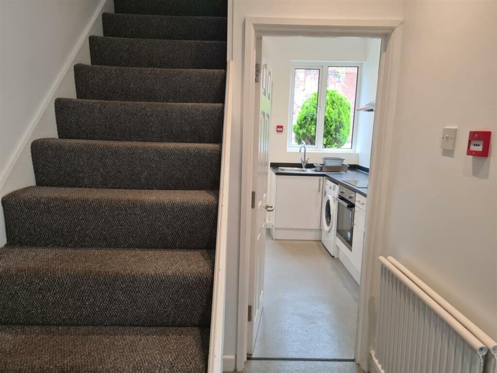 A tidy kitchen with ample natural light, ideal ...