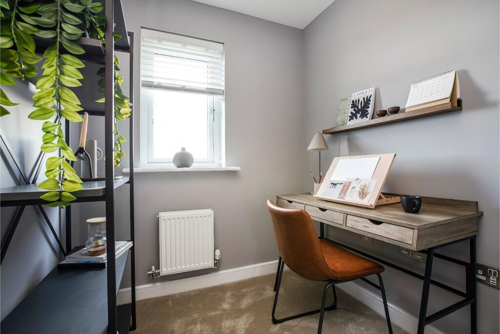 A compact and functional study room with a window that offers a pleasant view and natural light.