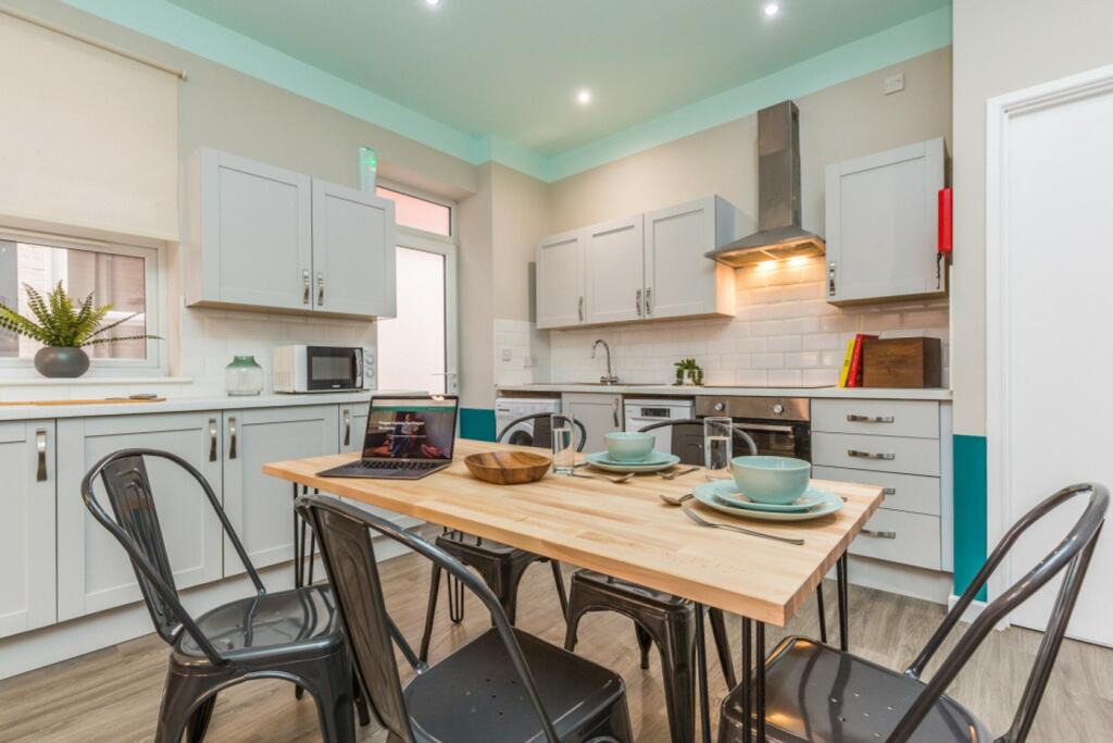 A modern and inviting kitchen with ample natura...