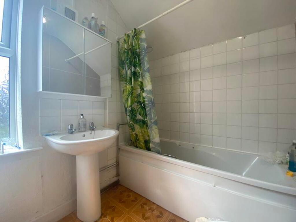 A bright and clean large bathroom featuring a b...