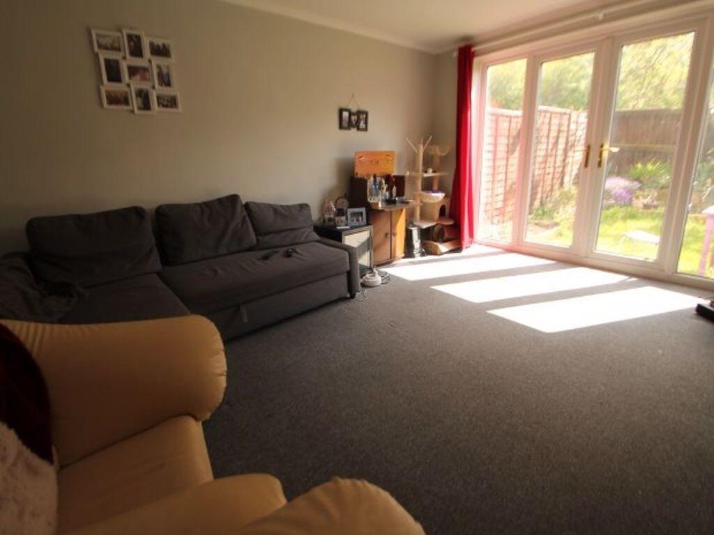 A bright and inviting living room with large gl...