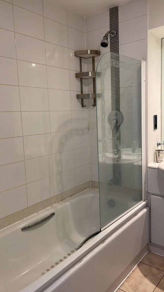 A modern bathroom featuring a stylish bath with...