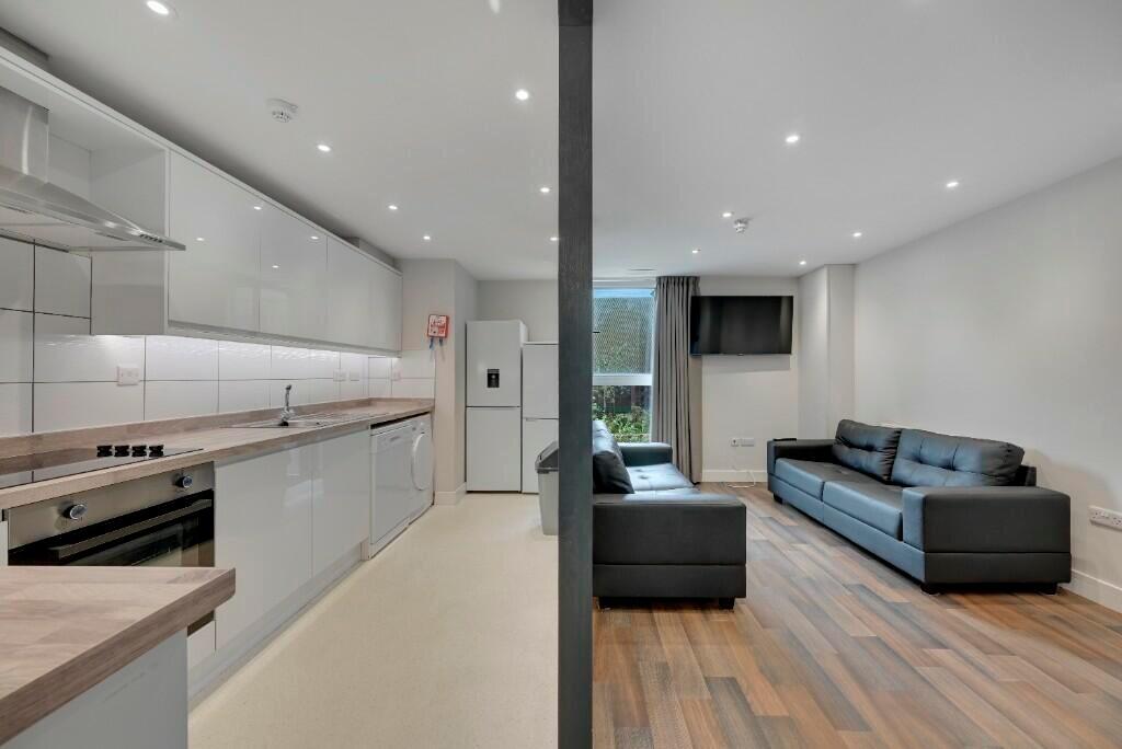 A modern, bright living room featuring sleek bl...