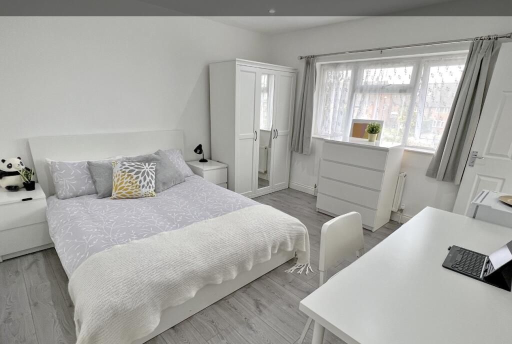 Bright and spacious master bedroom featuring a ...