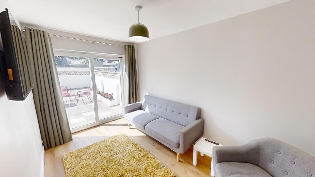Bright and cozy living room featuring a comfort...
